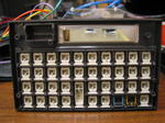 HP-12C front case with rubber membrane removed, showing double-shot injection molded keys.